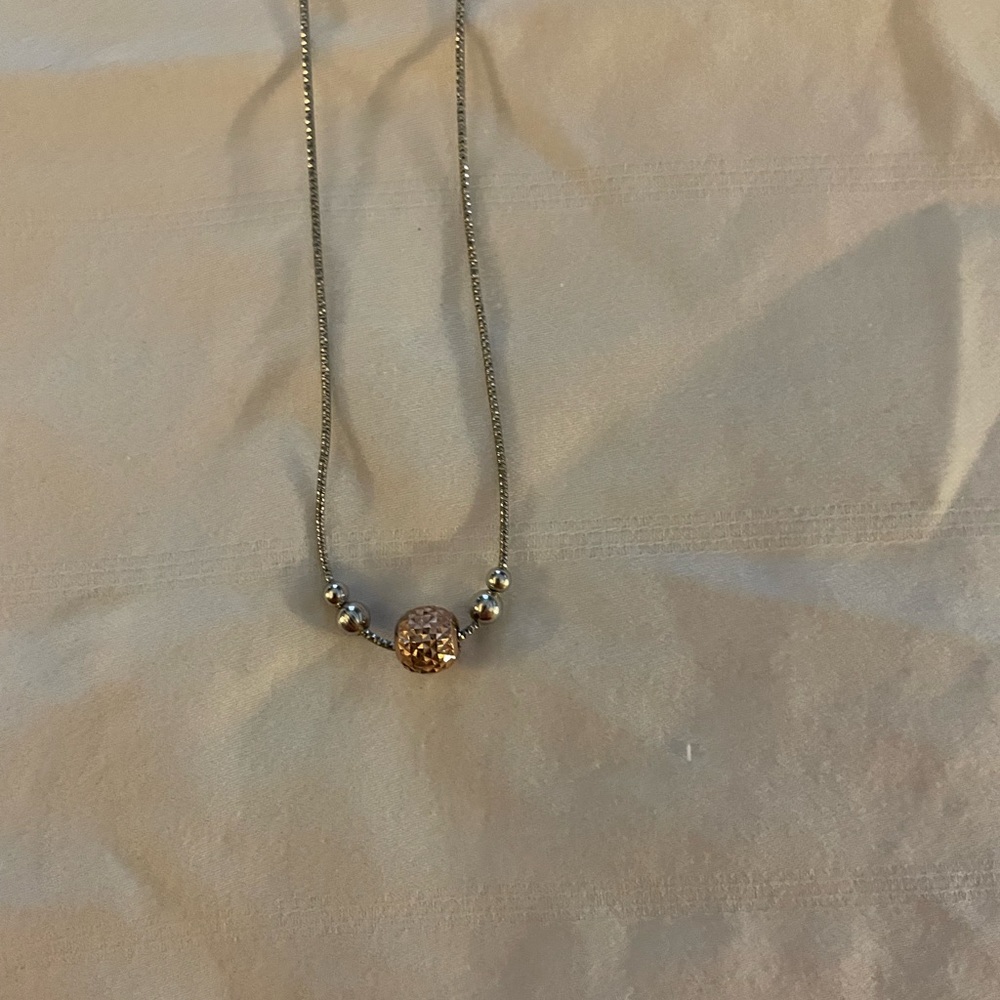 Sterling silver necklace with rose gold-colored ball, 19”.